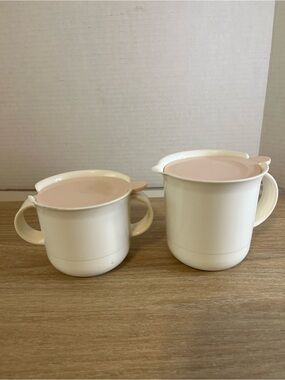Tupperware Ivory and Soft Pink Two-Piece Cream and Sugar Set with lids